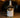 Bottle of Corte Vetusto Mezcal Ancestral on a wooden surface with a blurred background