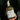 Bottle of Corte Vetusto Mezcal Ancestral held in a hand with a dark background