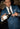 Man in a blue suit pouring a drink from a bottle of Corte Vetusto Ancestral Mezcal into a glass.